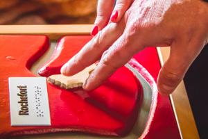 doigts sur un surface tactile en braille